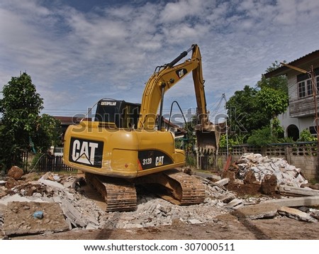 NONG KHAI, THAILAND - August 17, 2015: Tracked Excavator pull down the building to build a new house on August 17, 2015 at Mueang Nong Khai Municipality, Thailand