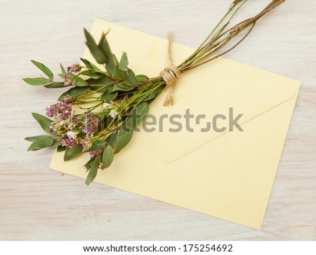 bouquet of wild flowers and an envelope on the table