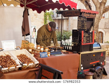 December 30, 2012. A man sells roasted chestnuts on the street in the small French town of Cassis, France.