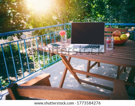 Image, Stock Photo Laptop on terrace table in front of flowers