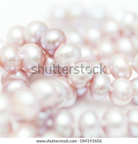 string of pearls delicate pink color, in soft focus, with highlights