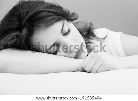 beautiful young woman sleeping, hugging pillow,  black and white