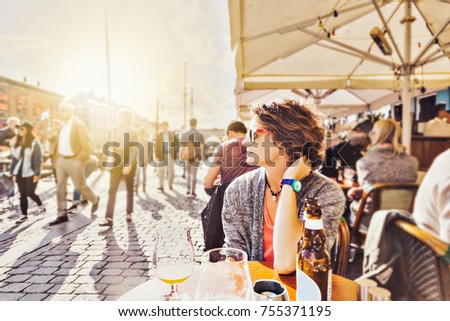 Similar – Image, Stock Photo Cute woman sitting outdoors while using a phone