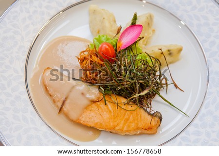 Salmon steak sauce gravy with mashed potatoes on plate