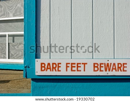 bare feet sign on food shack at beach