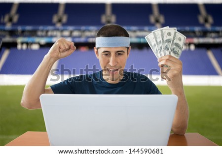 man betting online and making a lot of dollar in stadium