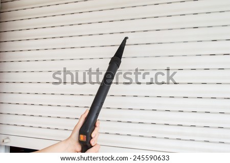 woman cleaning with steam roller shutter