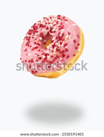 Similar – Foto Bild Mehrfarbige Donuts mit Zuckerstreuseln bestreut fliegen auf einem gelben Hintergrund