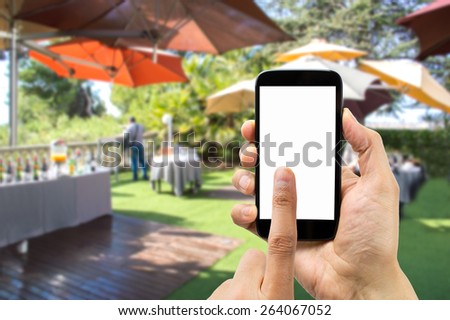 Hand holding smartphone with index finger touching the screen on the