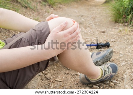 woman with knee pain after falling down the road