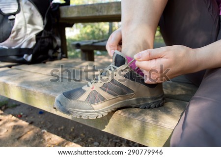 closeup of trekking boots being tied by woman getting ready for trekking