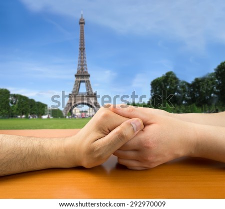 female hands grasping a man in concept of love in Paris