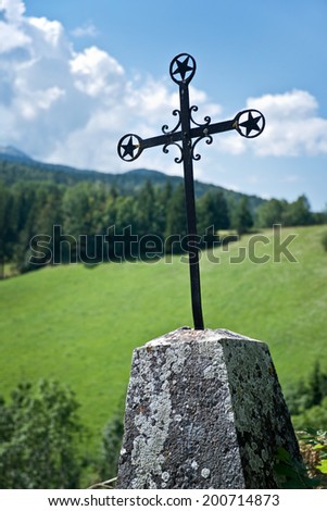 Old cross on the side of the road in the mountains of Vercors, France