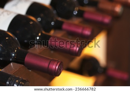 Bottles of red wine on a wooden shelf