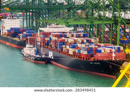 SINGAPORE, MAY 7: Container ship in the port of Singapore, the busiest asian commercial port with cargo ships and containers, on May 7, 2015 in Singapore