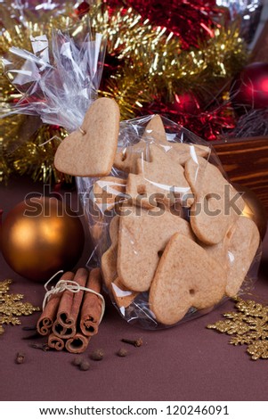 Homemade cinnamon cookies with cinnamon sticks and christmas decorations on background