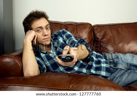 Young man on couch with remote control