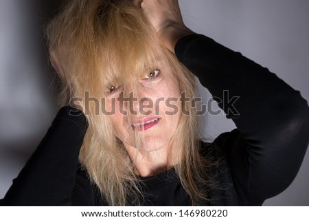 Crazy, angry woman pulling hair out  for mental health concept