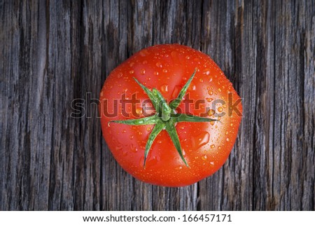 Organic tomato with water droplets