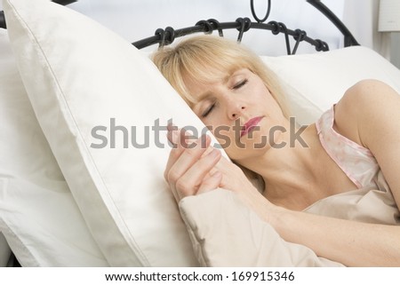 A middle age woman peacefully sleeping