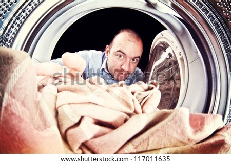 portrait of man view from washing machine inside
