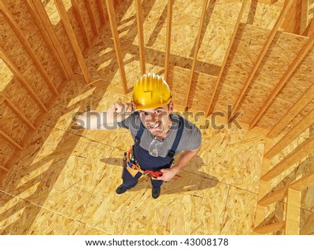 young caucasian smiling handyman in construction site