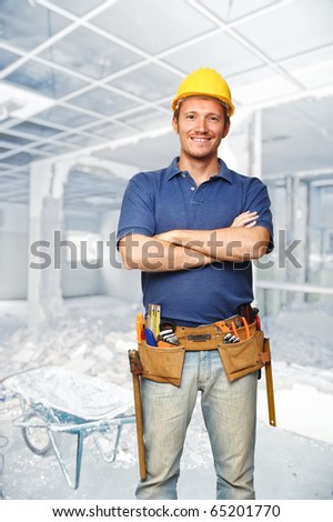 smiling handyman and construction site background