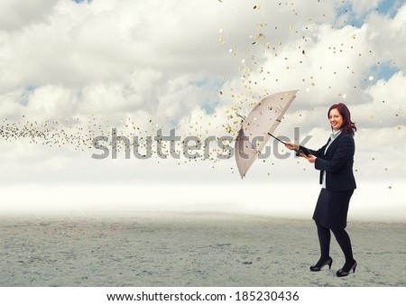 businesswoman with umbrella and money rain