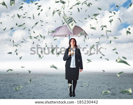 businesswoman with umbrella and money rain