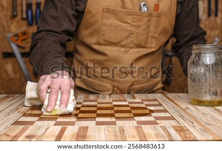 Similar – Image, Stock Photo Craftsman applying varnish to wood jalousie using airbrush in carpentry workshop