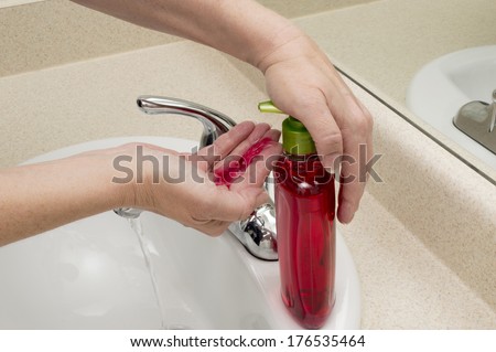 Female Hand Pumping Liquid Soap Into Palm Of Hand/ Horizontal Shot/ Ready To Clean Hands/ Some Smudging Intentional On FaucetCh