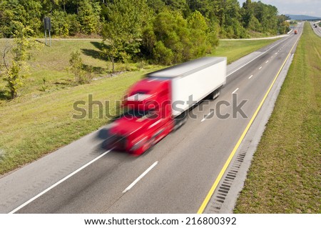 Red Truck Speeding Down The Highway/ Blurred Motion/ Scenic Horizontal Color Image