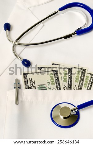 Vertical Shot Of Accurately Copied Money Sticking Out Of Doctor Coat With Stethoscope