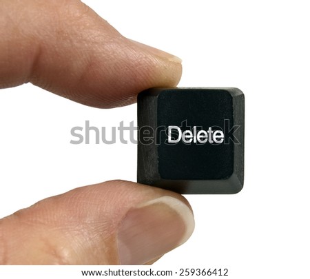 Holding The Delete Key From Computer Keyboard On White Background