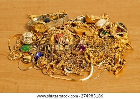 Pile Of Gold Jewelry On Wooden Table/ Pile Of Gold Jewelry