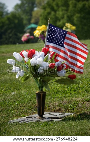 Flowers and flag for a fallen soldier/ Casualty Of War Fallen Soldier