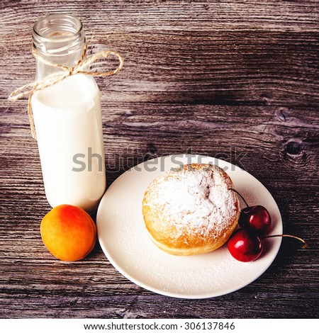 Cookies and bottle of  milk on wooden background