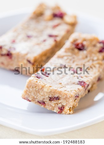 Natural homemade protein bars with peanut butter, honey, oats, nuts and cranberries.
