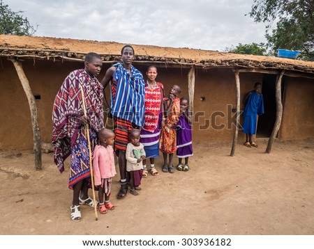 HANDENI, TANZANIA - AUGUST 01, 2015: Maasai family wearing traditional everyday clothes in their boma (village) in Tanzania, Africa.