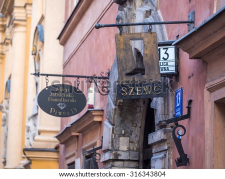 WARSAW, POLAND - JULY 16, 2015: Sign reading cobbler on Piwna street in the Old Town of Warsaw, Poland.