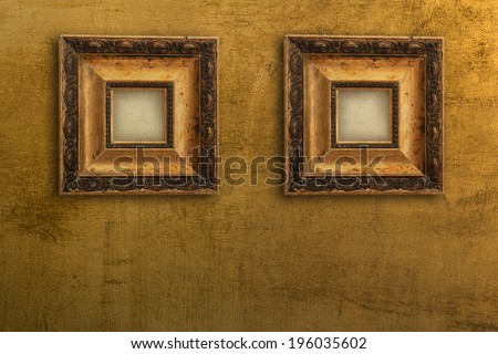 two vintage gold picture frames on the wall gold
