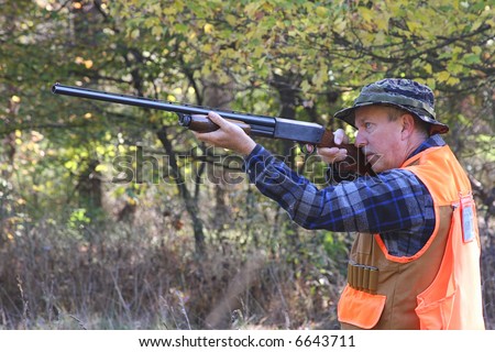 Man hunting and shooting a shot gun