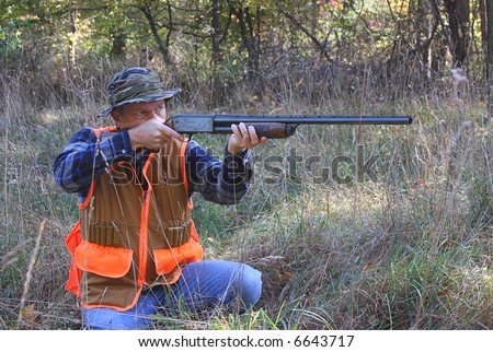 Man hunting and shooting a shot gun
