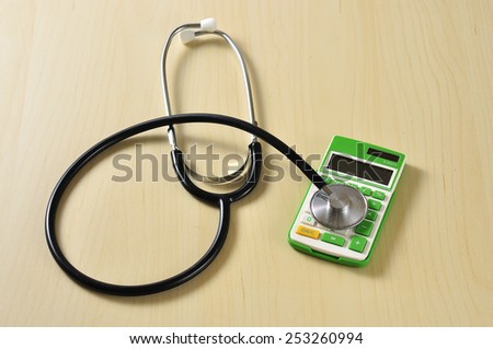 Stethoscope with Calculator on Desk, Medical Cost Concept and Selective Focus