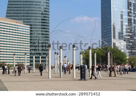 PARIS - SEPTEMBER 04: Tourists walking in the central square of La Defense a major business district of Paris, on September 04 2012 in Paris, France. La Defense welcomes 8.4 million visitors each year