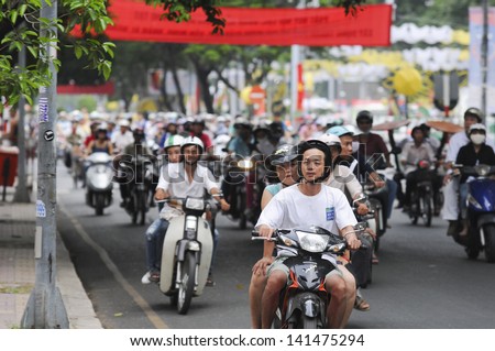 HANOI - JUNE 14: Unidentified riders ride motorbikes on busy road on June 14, 2010 in Hanoi, Vietnam. Motorbike is the most favorite vehicle for Hanoians, so Hanoi is always called the motorbike city.