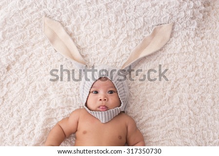 Close-up Portrait of a asian baby boy wearing rabbit hat