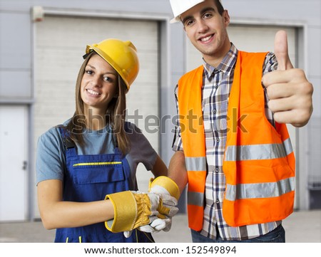 Happy worker and business man holding their thumbs up