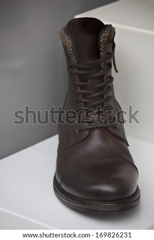 Brown man's shoes.Black boots
