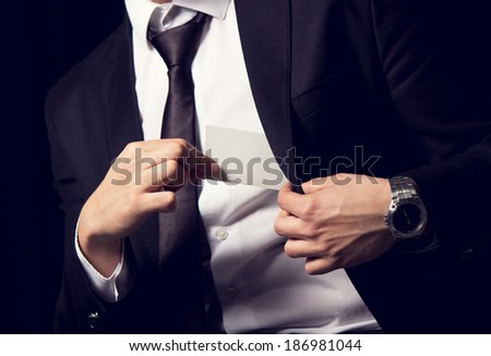 Man's hand showing business card